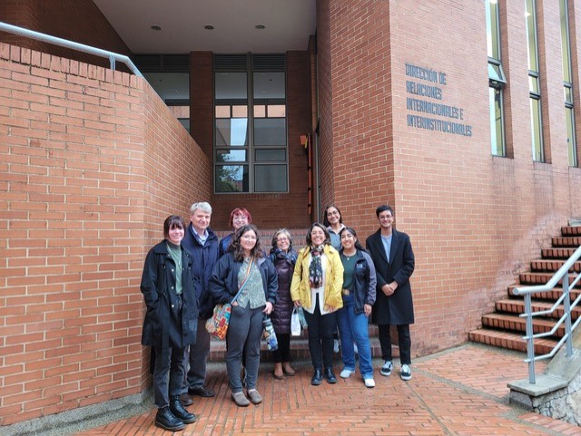 Students pose in front of building