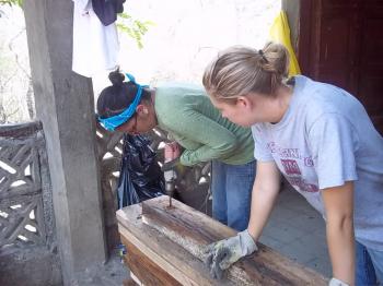 Image of women drilling unto wooden planks - ewb3